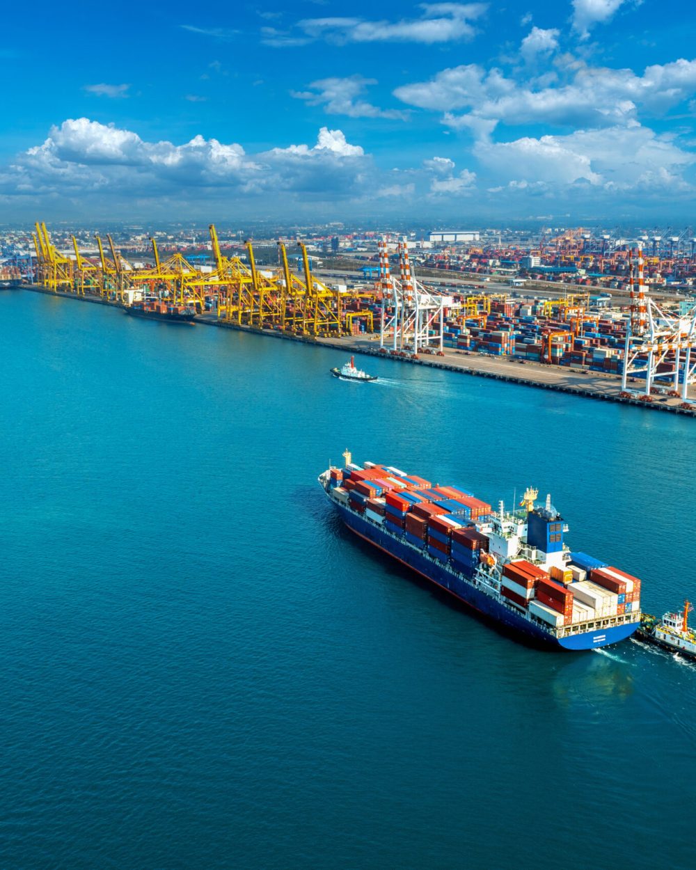 Aerial view of cargo ship and cargo container in harbor.